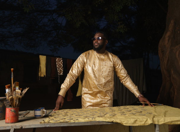 Bogolan in beige on man painting