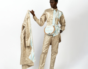 Model poses in beige suit